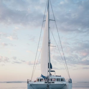catamaran head on with clouds