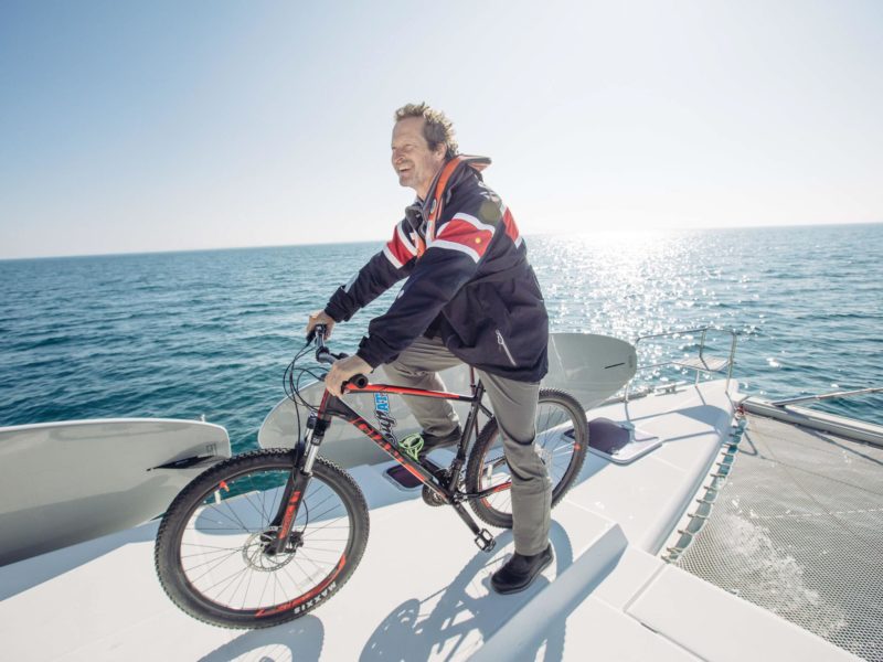 man on bike while sailing on Catamaran in Lake Superior