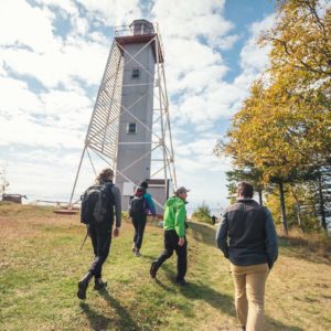 students walking by lighthouse