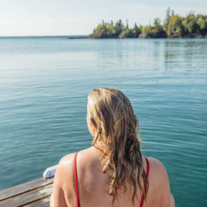 blonde sitting at the end of the dock