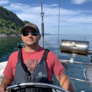 Male at the Helm of Frodo on Lake Superior