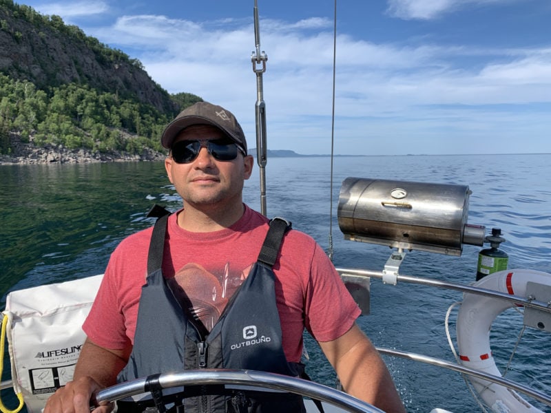 Male at the Helm of Frodo on Lake Superior