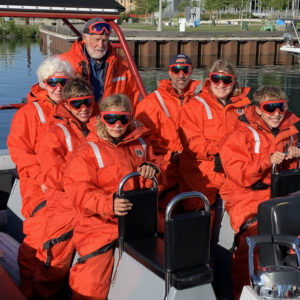 Zodiac passengers in full floater suits aboard the Superior Zodiac