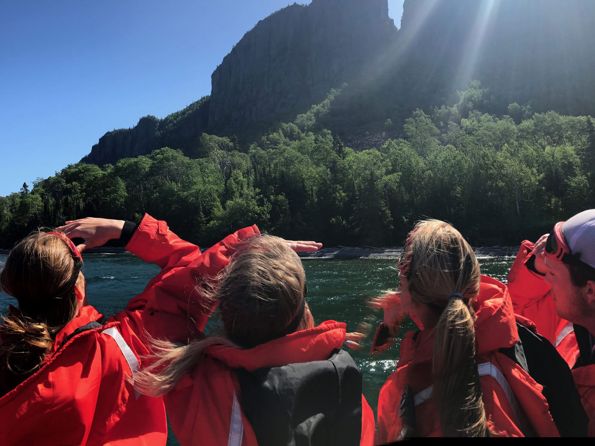 Zodiac passengers looking up to the Sleeping Giant