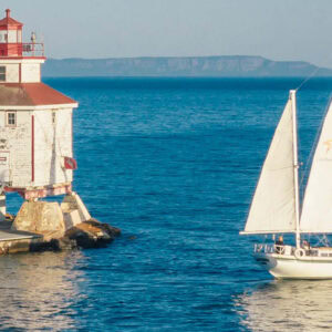 Journeyer our Downeaster 38 Ketch sailing in the bay near the Thunder Bay main lighthouse