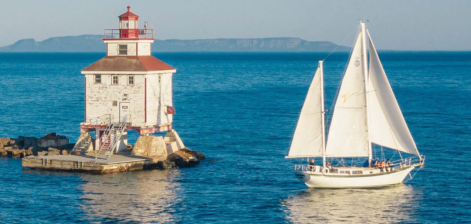 Journeyer our Downeaster 38 Ketch sailing in the bay near the Thunder Bay main lighthouse