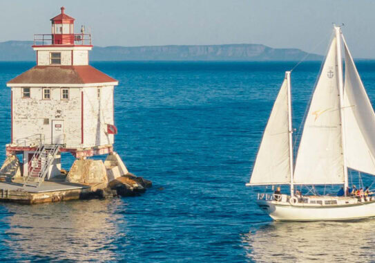 Journeyer our Downeaster 38 Ketch sailing in the bay near the Thunder Bay main lighthouse