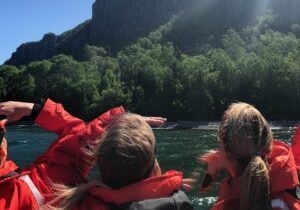 Zodiac passengers looking up to the Sleeping Giant