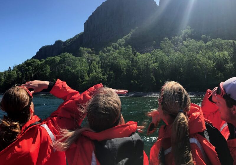 Zodiac passengers looking up to the Sleeping Giant